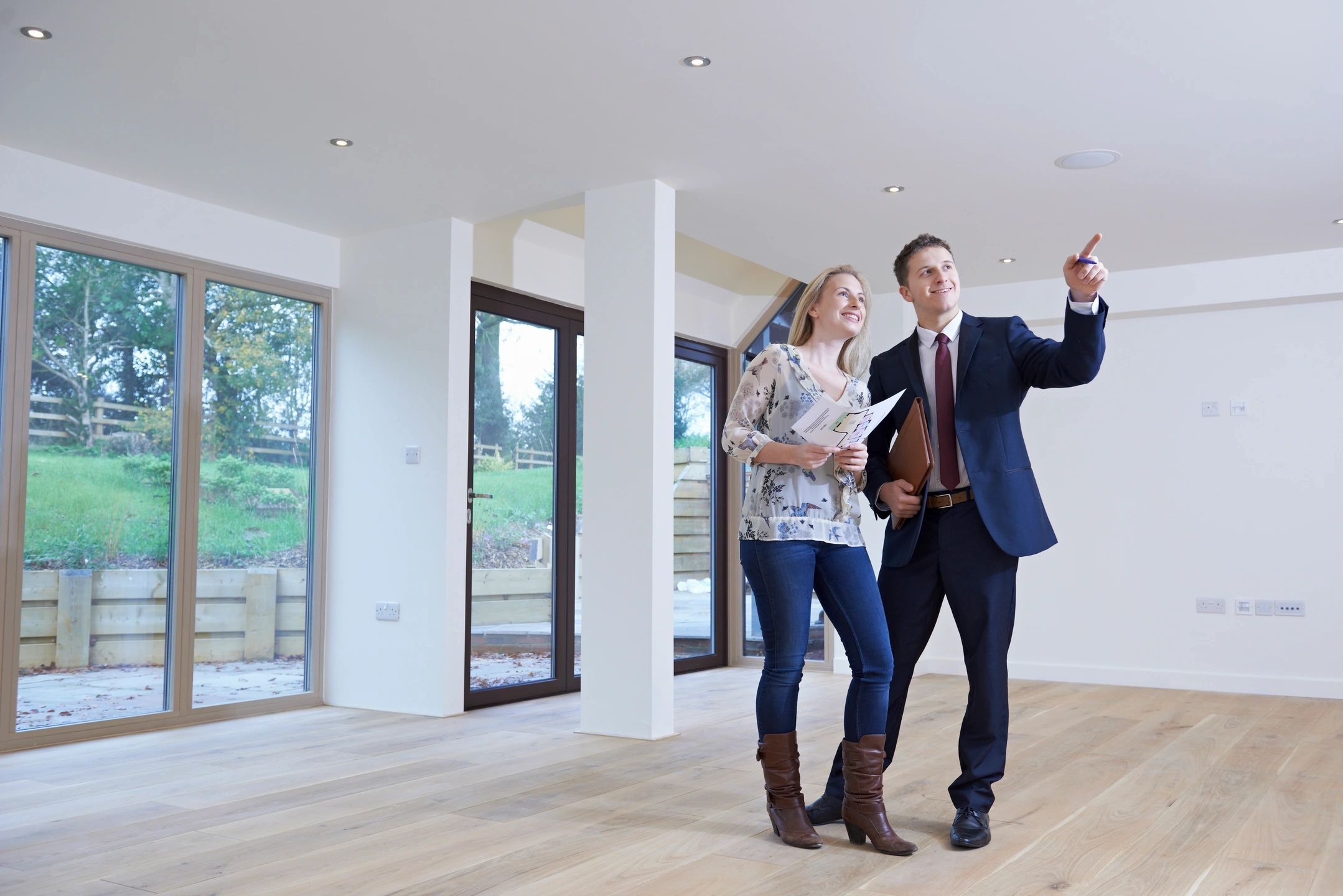 Real estate agent showing modern interior to client