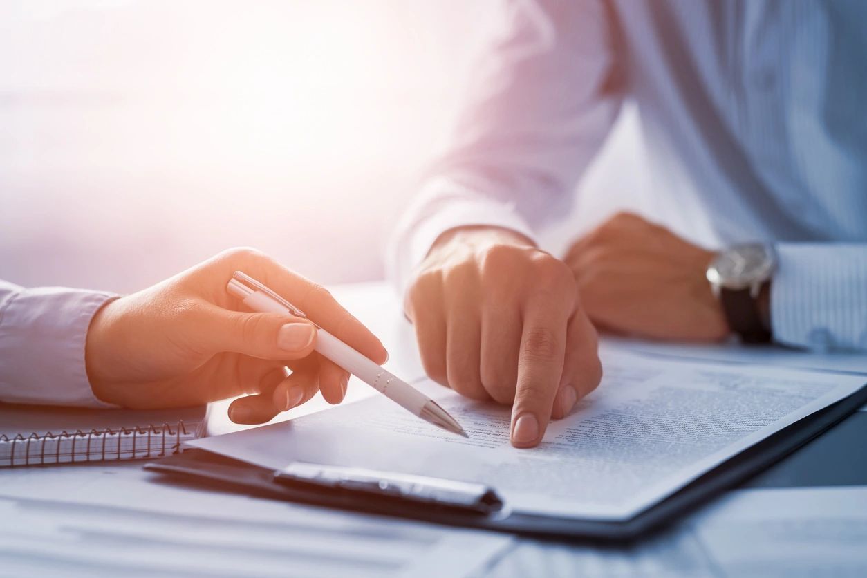 Hands signing loan documents